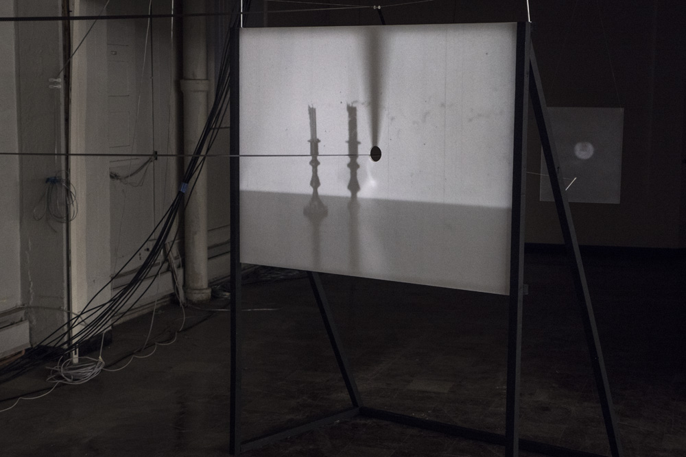 Four Shadows<br />looping 16mm film projection through punctured screen<br />2015-2016